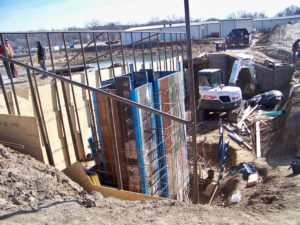 Crews from Mid-State Pipeline Maintenance of Belle work on digging and setting forms for the new UV disinfectant treatment system near the lagoons at the Chamois waste water treatment facility on Jan. 30, 2018.