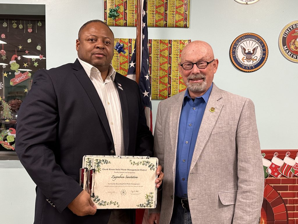 Waynesville Mayor Sean Wilson receives an award on behalf of Zeigenbein Sanitation 