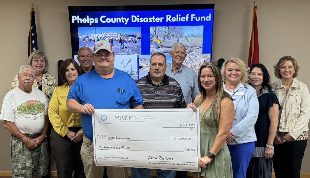 Stacy Yoakum and Kim Squires of the Phelps County Fair accept a $10,000 grant from the Phelps County Disaster Relief Fund to rebuild the Home Arts building at the fairgrounds that was damaged by the March 14 tornado in Rolla and Phelps County. Board members of Meramec Regional Community Foundation and the Phelps County Community Foundation made the grant award at the July 9 Annual Meeting of the MRCF. 