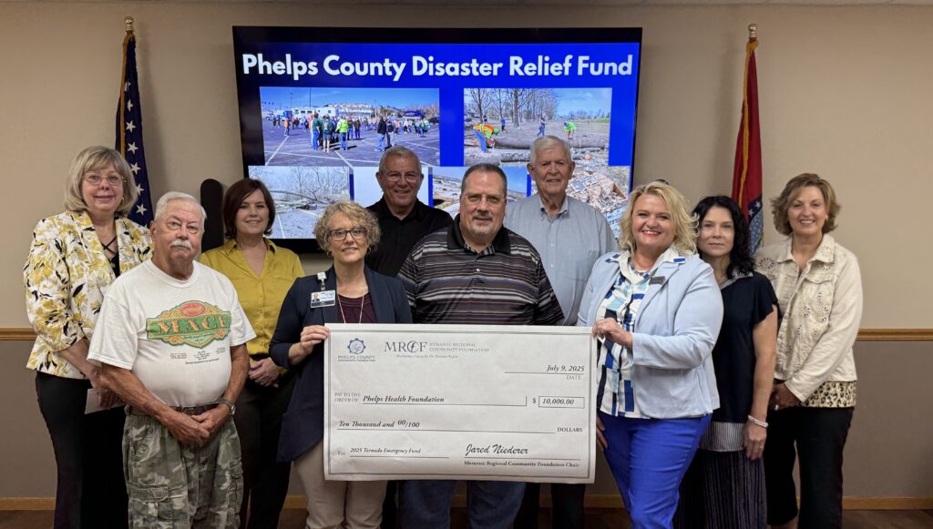 Laura Light of the Phelps Health Foundation accepts a $10,000 grant from the Phelps County Disaster Relief Fund to assist Phelps Health patients and employees impacted by the March 14 tornado in Rolla and Phelps County. Board members of Meramec Regional Community Foundation and the Phelps County Community Foundation made the grant award at the July 9 Annual Meeting of the MRCF. 